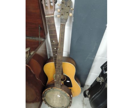 A vintage acoustic guitar body stamped 222 and a traditional 5 string banjo frame with brass embellishments to headstock and 