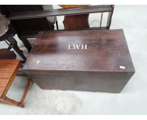 A vintage wooden travel trunk, monogrammed L.W.H.