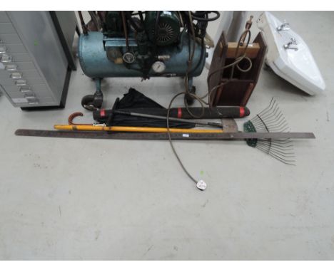 A selection of tools including ;long metal rule, rake etc