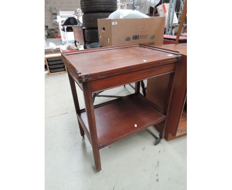 A vintage mahogany fold over tea/games trolley