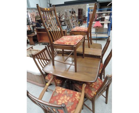 A modern Ercol extending table and ten ( eight plus two) dining chairs