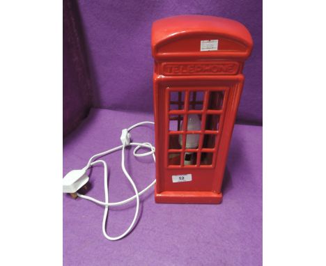 A table top lamp in the design of a red phone box