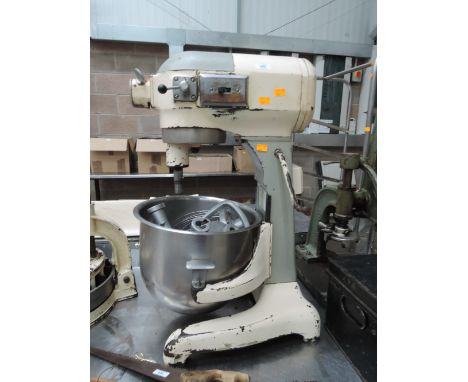 A vintage Hobart commercial food mixer with stainless steel bowl and tools