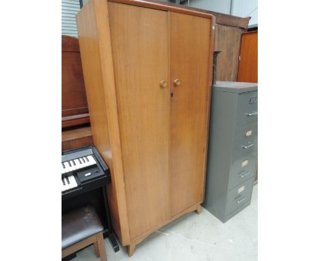 A vintage golden oak wardrobe, labelled Austin suite