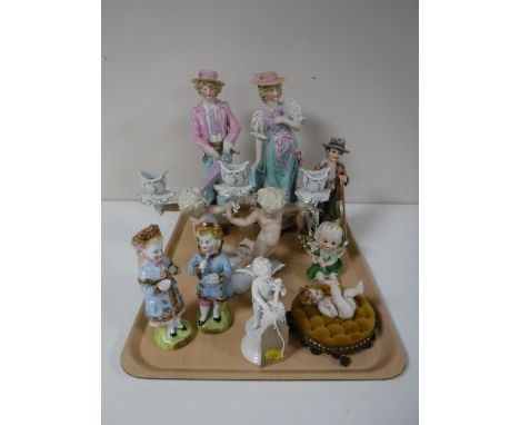 A tray containing continental figurines, including cherub with cello, cherub candlestick holder, goat herder etc 