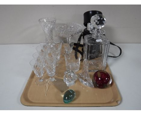 A tray containing glass paperweights, etched glass whiskey decanter, a Grants scotch whiskey hip flask set, glass comport