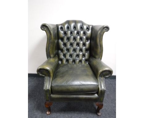 A green button leather Chesterfield chair 