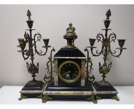 A three piece black slate and marble French clock garniture 