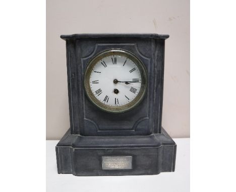 A late nineteenth century black slate mantel clock with enamelled dial 