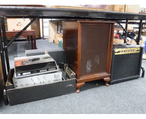 A Marshall amplifier, Technics amp, VCR DVD player, two speaker cabinets with speakers, a PC tower and a Denon turn table 