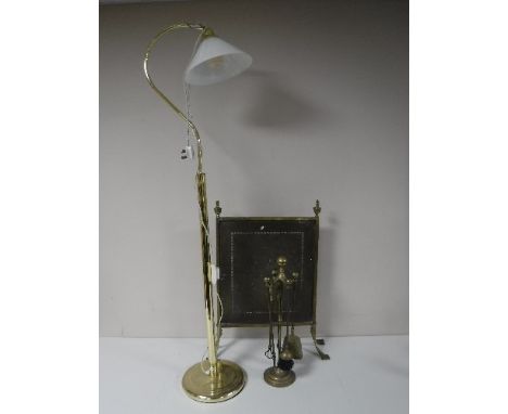 A brass floor lamp with shade, brass fire screen and companion set 