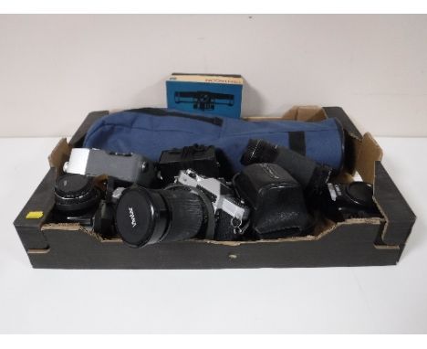 A box containing Chinon, Minolta, Practika cameras, camera lenses, Cine camera 