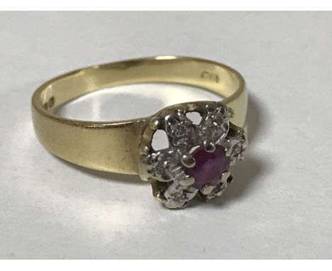 An 18ct gold ruby and diamond cluster ring, size K/L, 2.6g.