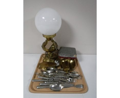 A tray containing a brass oil lamp with glass shade, converted, assorted table cutlery, brass trivet and box, etc 