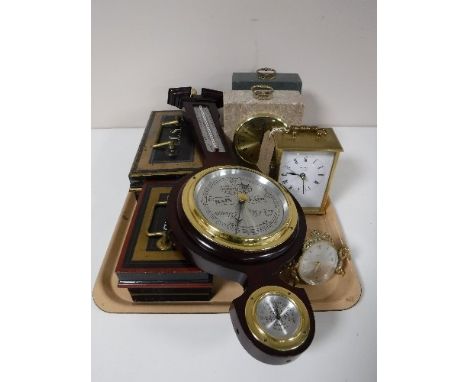 A tray containing two Cumbrian marble mantel clocks, brass carriage clock, two vintage cash boxes, a Swiza cherub desk clock,
