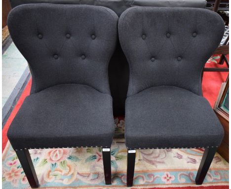 A pair of contemporary wingback side chairs, stuffed over button back upholstery (2)