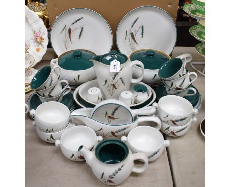 A Denby Greenwheat pattern part dinner and tea set comprising dinner plates, side plates, serving dishes, vegetable dishes, s