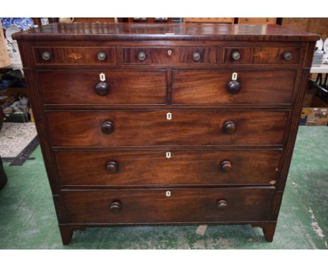 A George III mahogany chest of three shallow, two short and three long cockbeaded drawers, two shallow drawers with inlaid sh