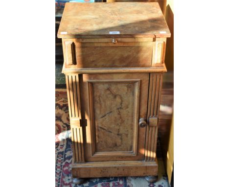 A 19th/early 20th century walnut pot cupboard, rectangular top above a slide and a panel door enclosing a shelf flanked by fl