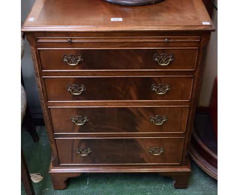 A reproduction mahogany chest of four long graduated cockbeaded drawers below a slide, the top 'crossbanded', fluted chamfere