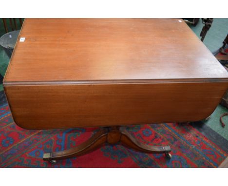 A 19th century mahogany sofa table, rounded rectangular top with fall leaves above a pair of frieze drawers, sabre legs, bras