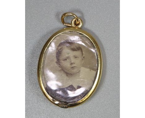 9ct gold locket  set with enamel and seed pearl, containing photograph of a young boy.  3.9g approx.  (B.P. 21% + VAT) 