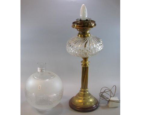 Early 20th century oil  lamp base now converted to electricity, having etched globular shade, fluted glass reservoir on a bra