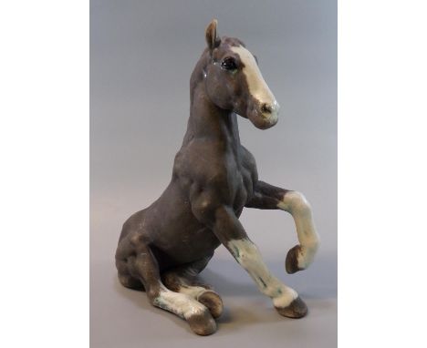 Raku pottery model of a seated horse by 'K Rudge', signed.  31cm high approx.  (B.P. 21% + VAT) 