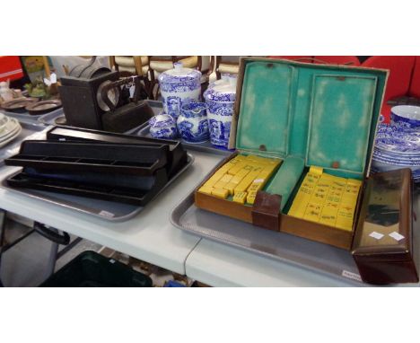 Vintage MahJong travelling set (possibly 1920s) with yellow tiles decorated in red, green and black in a battered leather cas