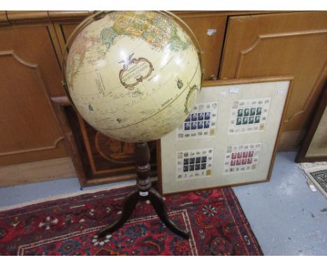 Reproduction globe on stand (at fault) together with a framed marquetry picture and four framed sheets of Russian stamps