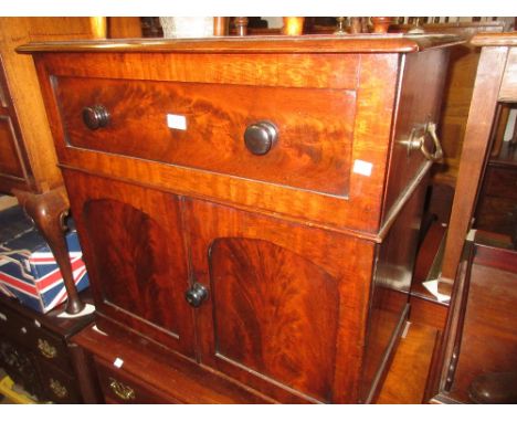 Victorian mahogany commode with a hinged lid above two panelled doors on a plinth base