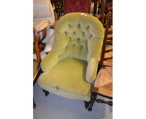 Victorian green button upholstered iron frame tub shaped chair raised on turned tapering ebonised supports