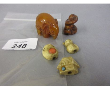 Carved boxwood ojime together with three bone ojime and a composite elephant netsuke