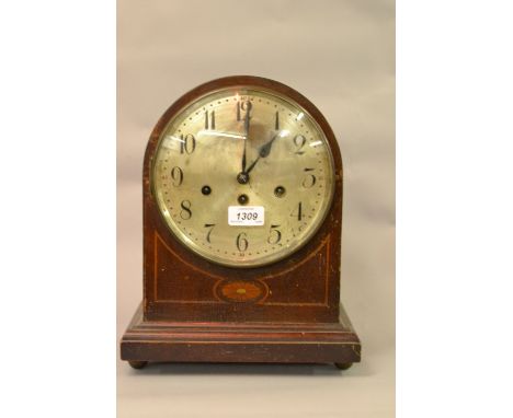 Edwardian mahogany and inlaid dome shaped mantel clock with a silvered dial, Arabic numerals and three train movement
