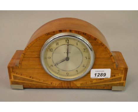 Art Deco walnut and inlaid dome shaped mantel clock together with a 19th Century ebonised mantel clock