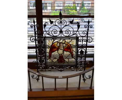 Good quality Arts and Crafts wrought iron fire screen inset with a leaded glass panel painted with an eagle
