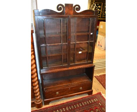 Small mahogany bookcase with two bar glazed doors above an alcove and drawer, raised on bracket feet, George III period and l