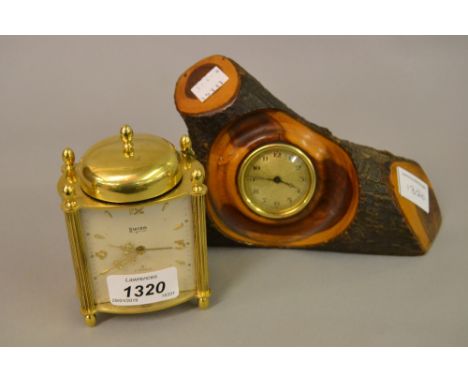 Swiza brass alarm clock together with a small clock movement mounted to an olive branch