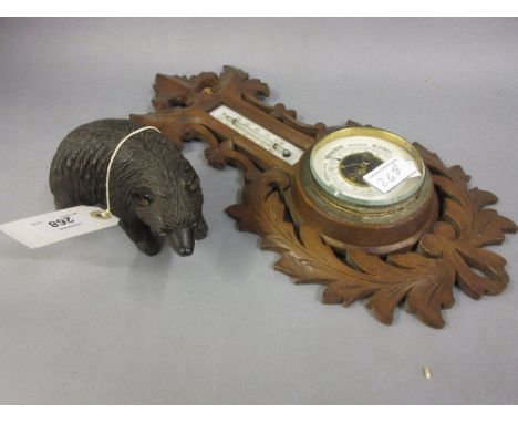 Black Forest carved wooden figure of a bear together with a Black Forest aneroid barometer thermometer