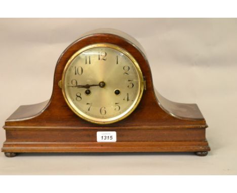 20th Century mahogany dome topped mantel clock having silvered dial with Arabic numerals and two train movement striking on a
