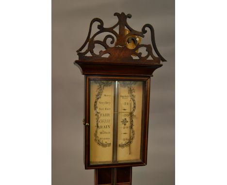 Reproduction mahogany and inlaid stick barometer together with a carved oak aneroid barometer thermometer