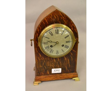 Edwardian oak and chequer inlaid lancet shaped mantel clock with a silvered dial, Roman numerals and two train movement