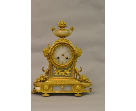 19th Century French ormolu and alabaster mantel clock with an urn surmount and mask head sides on a shaped base, the alabaste