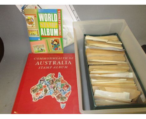 Commonwealth of Australia stamp album, smaller World stamp album and a box containing a quantity of various stamped envelopes