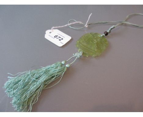 Early 20th Century Chinese carved and pierced pale green jade pendant on a green silk tasselled cord