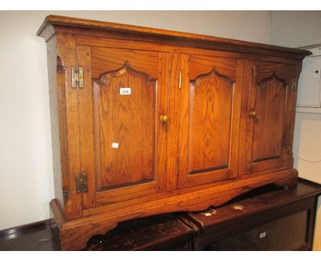 Good quality reproduction oak low side cabinet with three arched panelled doors on bracket feet