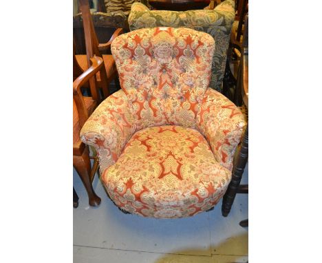 19th Century button upholstered low seat armchair raised on turned ebonised supports with casters