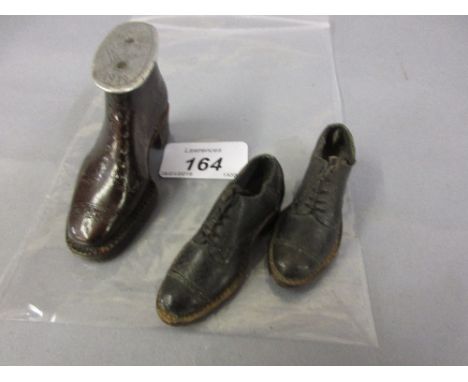 Miniature leather model shoe with pewter cover engraved with a flower and dated 1919, together with a pair of miniature leath
