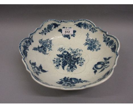 18th Century English blue and white floral decorated bowl decorated in relief with scallop shells and within a shaped border,