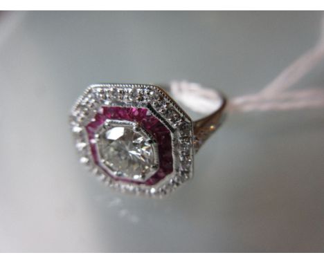 18ct White gold and ruby target style ring, the centre diamond approximately 0.65ct CONDITION REPORT Ring size M-NOf recent m